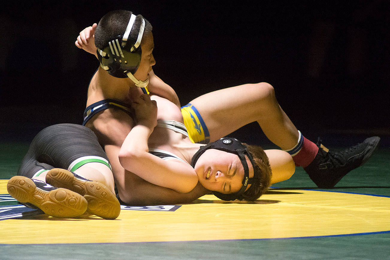 Erik Nguyen looks for nearfall on Kentwood’s Spencer Hill at 106 pounds. Photo by Kayse Angel