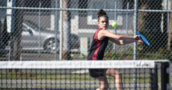 Renton’s Michelle Arjona-Reyes lines up a backhand shot against Hazen. Ben Ray / The Reporter
