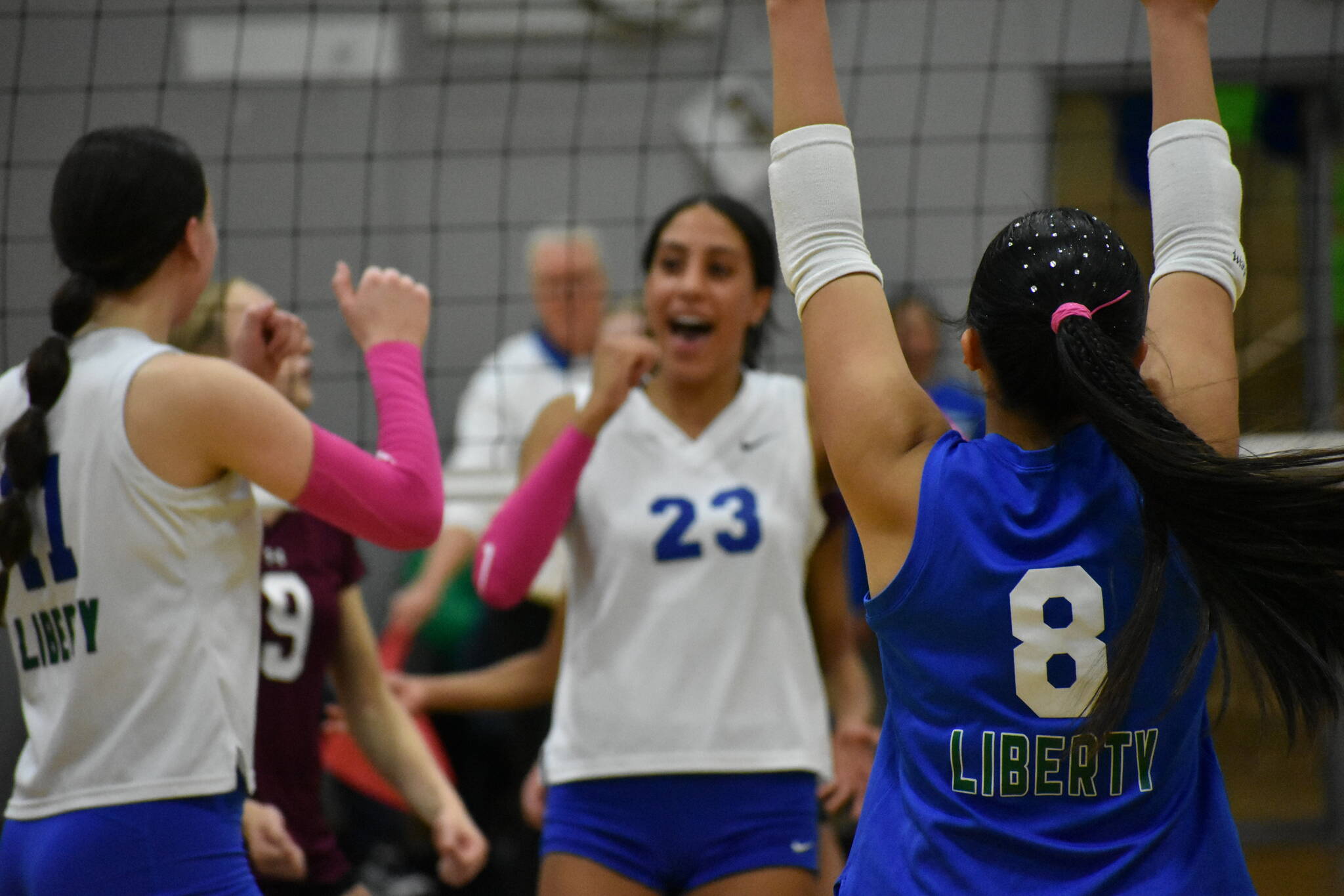Charlize Espinosa throws her arms in the air after a Kendreah Beazer spike against Mercer Island. Ben Ray / The Reporter