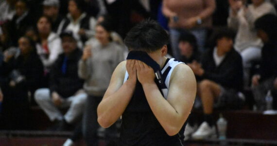 Trinidad Valentino English covers his face after falling to Sequim in the state tournament. Ben Ray / The Reporter