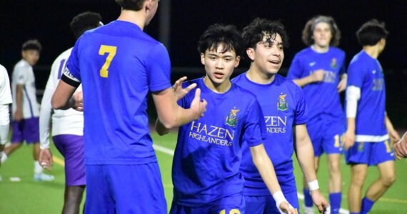 Stephen Cruz high fives Vitaly Polyukh after scoring the second Hazen goal of the game. Ben Ray / The Reporter