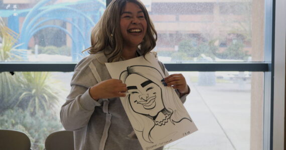 Fancy Vargas of Elevate PR will be the guest speaker at Renton Reporter’s next Read All About It chat night on April 29 at Drum Roll Wine. Vargas holds her caricature portrait by Markas Odom, who is @brother_caricature on Instagram. Photo by Bailey Jo Josie/Sound Publishing