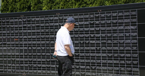 A man reads the names of U.S. veterans at Renton’s Veterans Memorial Park. Photo courtesy of the City of Renton