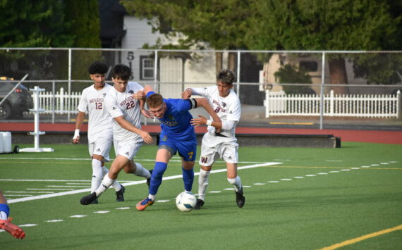 Vitaly Polyukh fends off three Wenatchee players. Ben Ray / The Reporter