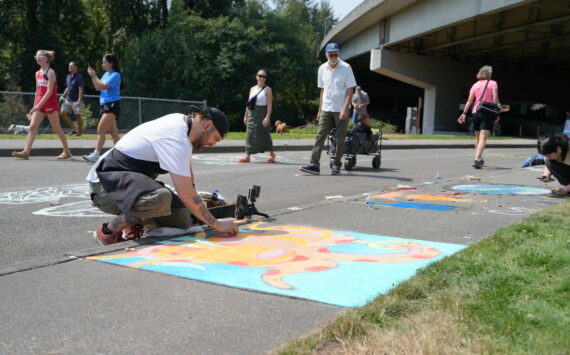 Michael Ingrassia works on his chalk art piece at last year’s competition. Photo provided by the City of Renton