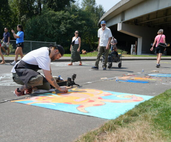 Michael Ingrassia works on his chalk art piece at last year’s competition. Photo provided by the City of Renton